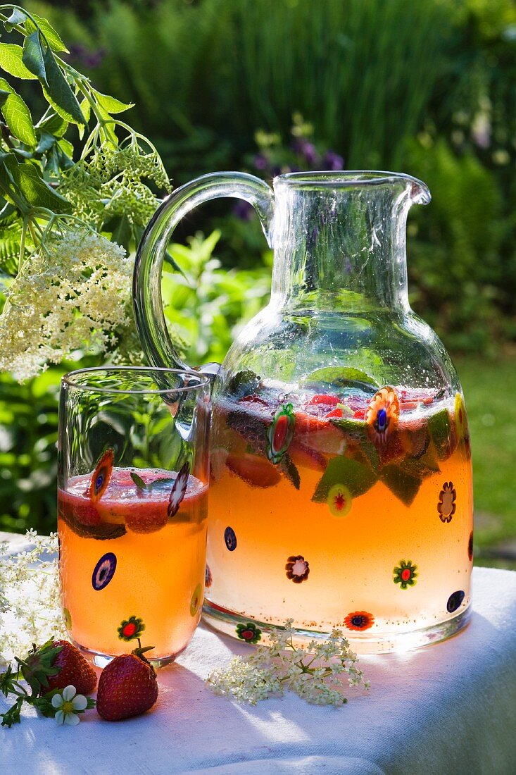 Champagne punch with elderflower syrup and strawberries