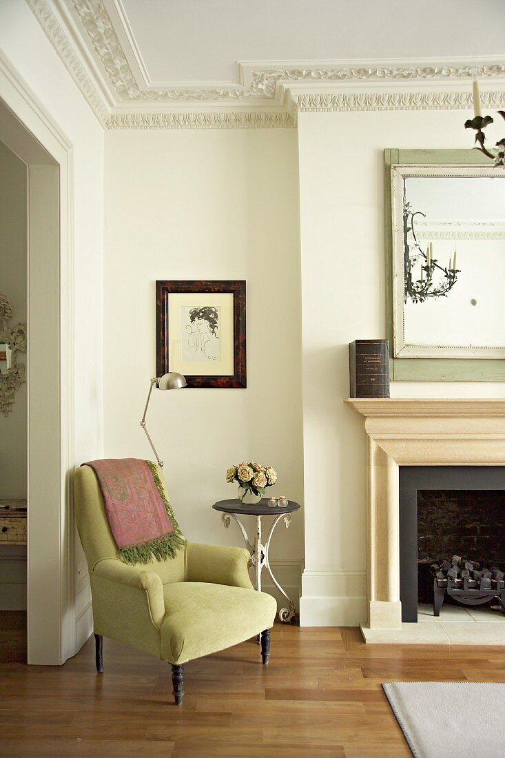 Corner of grand living room with comfortable armchair next to fireplace