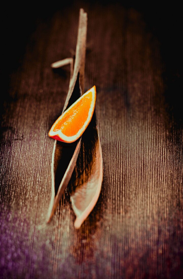 An orange wedge on a palm leaf