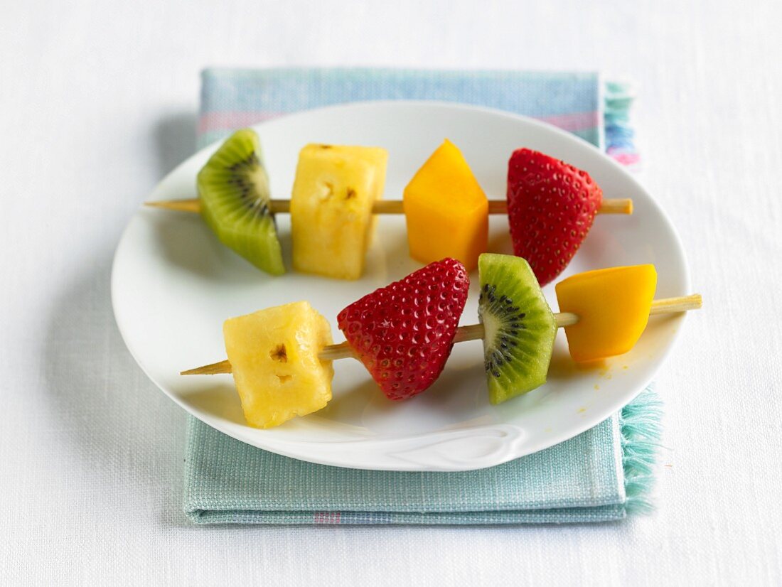 Two Fruit Kabobs on a White Plate
