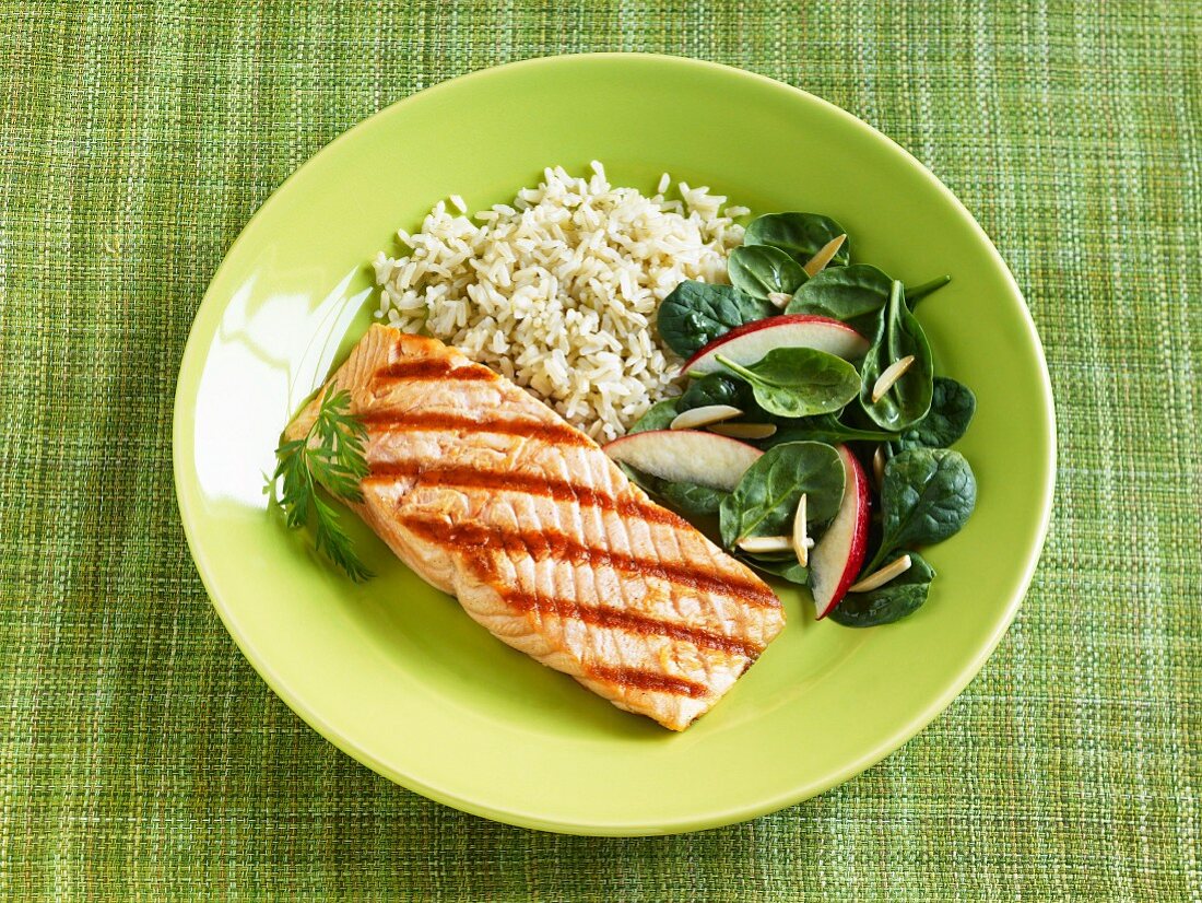 Grilled Salmon with Rice and Spinach Salad with Sliced Radish and Almonds; On a Green Plate