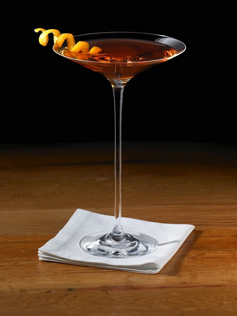 Sorriso Cocktail in a Stem Glass with Orange Peel Twist Garnish