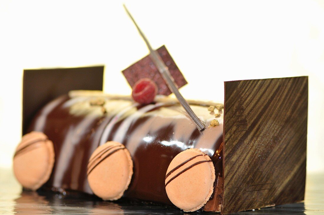 Chocolate roll decorated with macaroons
