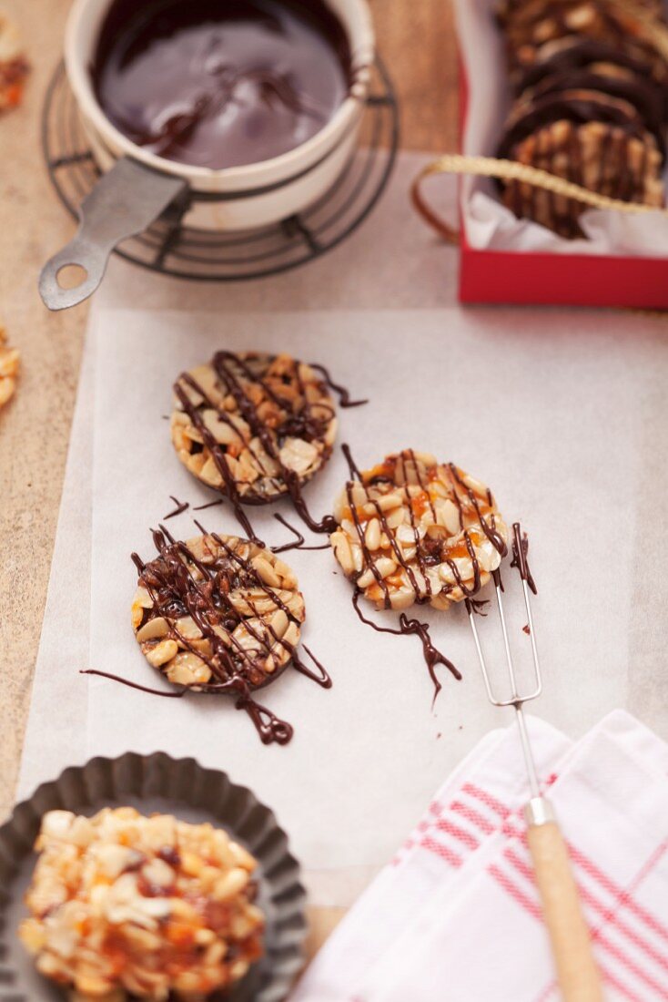 Florentines being decorated with chocolate icing