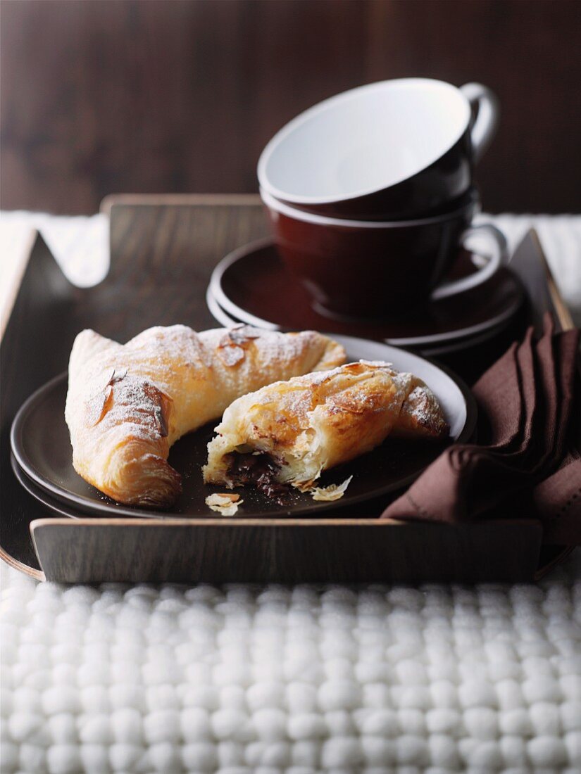 Chocolate croissants and coffee cups