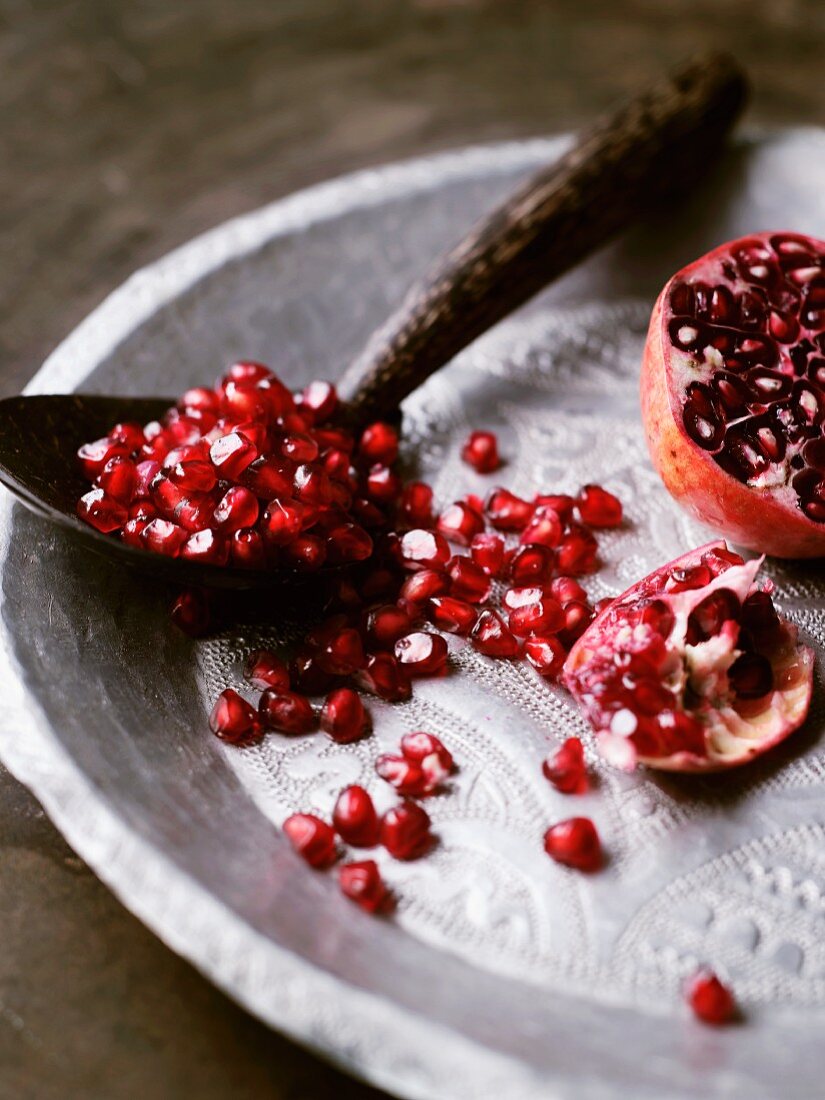 A sliced pomegranate and pomegranate seeds