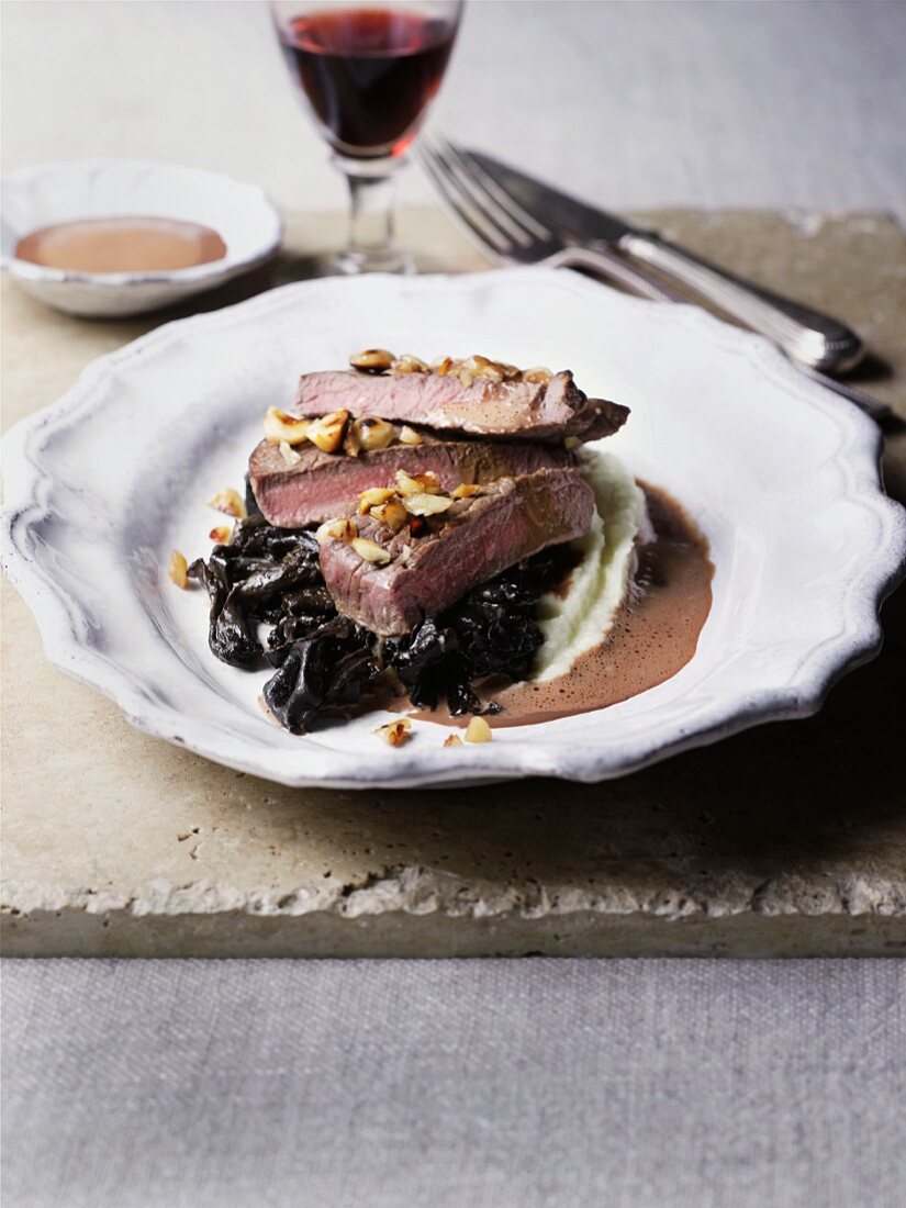 Venison fillet on a bed of mashed potatoes with prunes