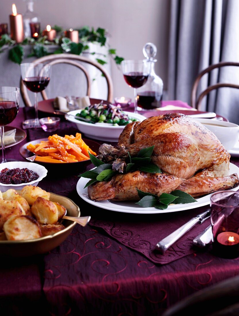Roast turkey and side dishes of a table laid for Christmas dinner