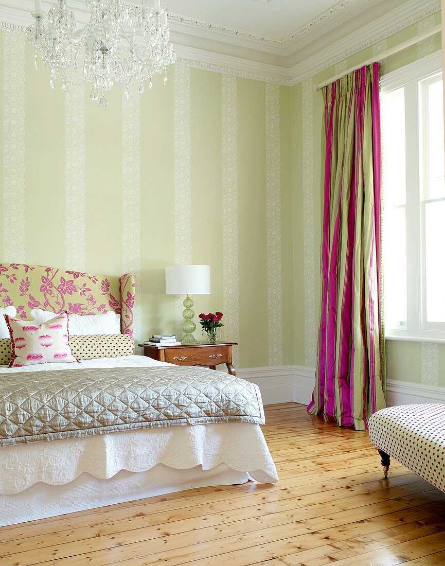 Traditional bedroom in pale pastel shades with cheerful deep pink accents in curtains and bed headboard cover