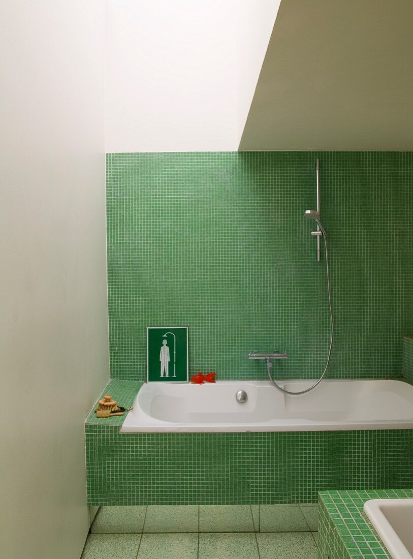 Contemporary bathroom with retro green mosaic tiles on bathtub panel and wall