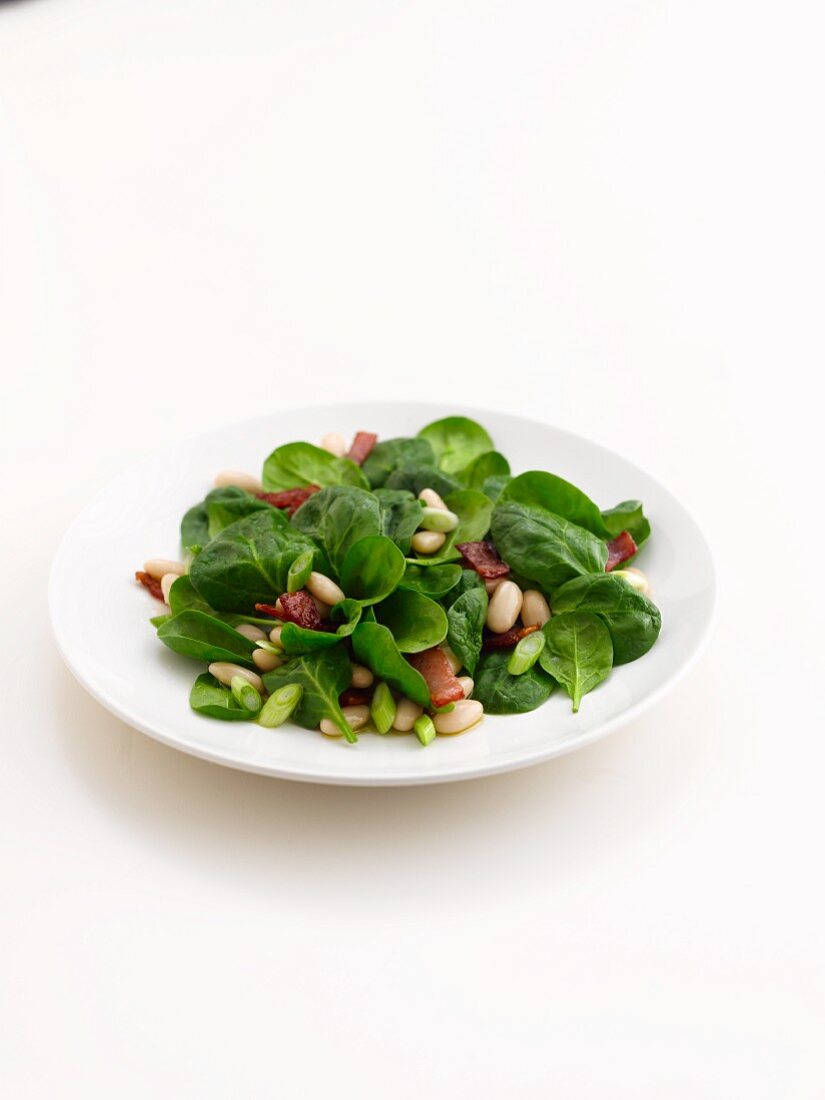 Spinach salad with bacon and pine nuts