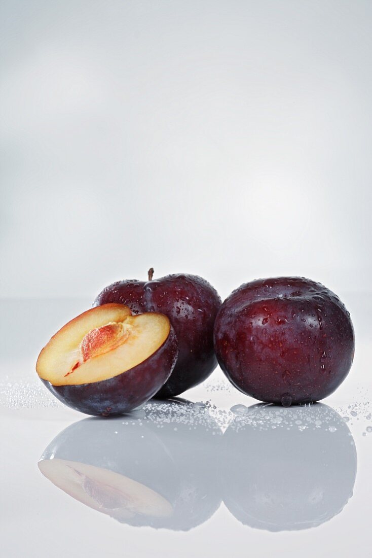 Plums, whole and halved