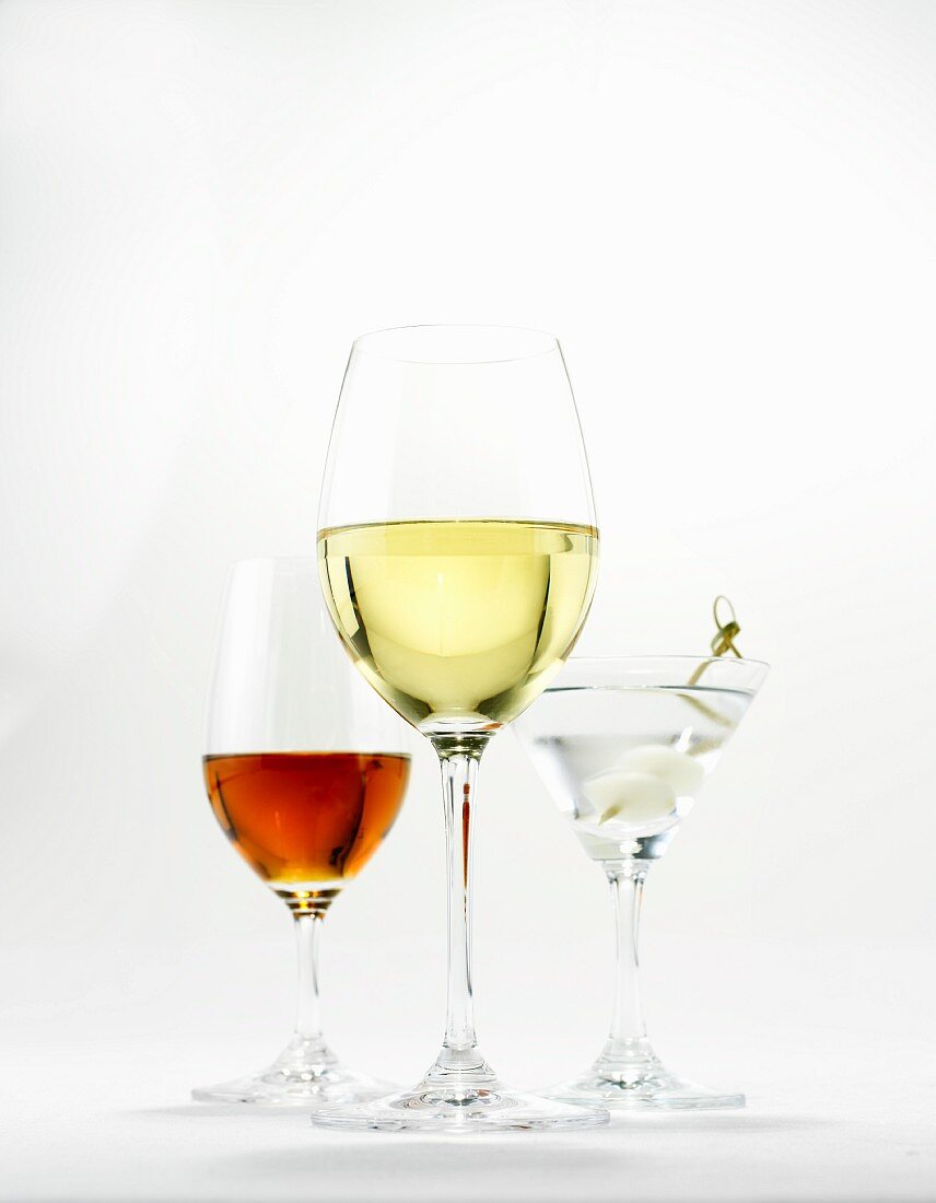 A glass of white wine, a martini and a glass of sherry