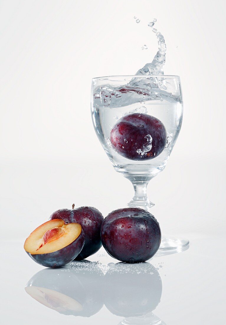 A damson falling into a schnapps glass
