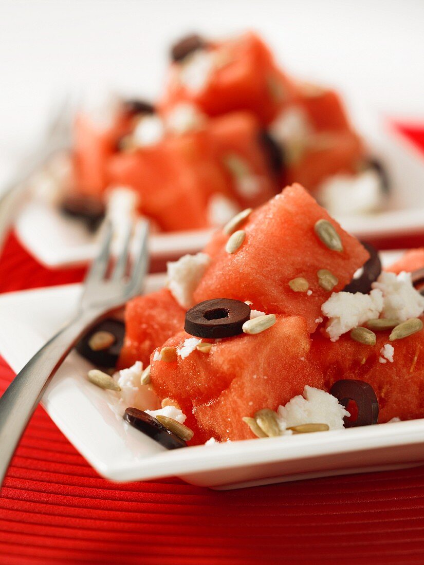 Watermelon salad with feta cheese, olives and sunflower seeds