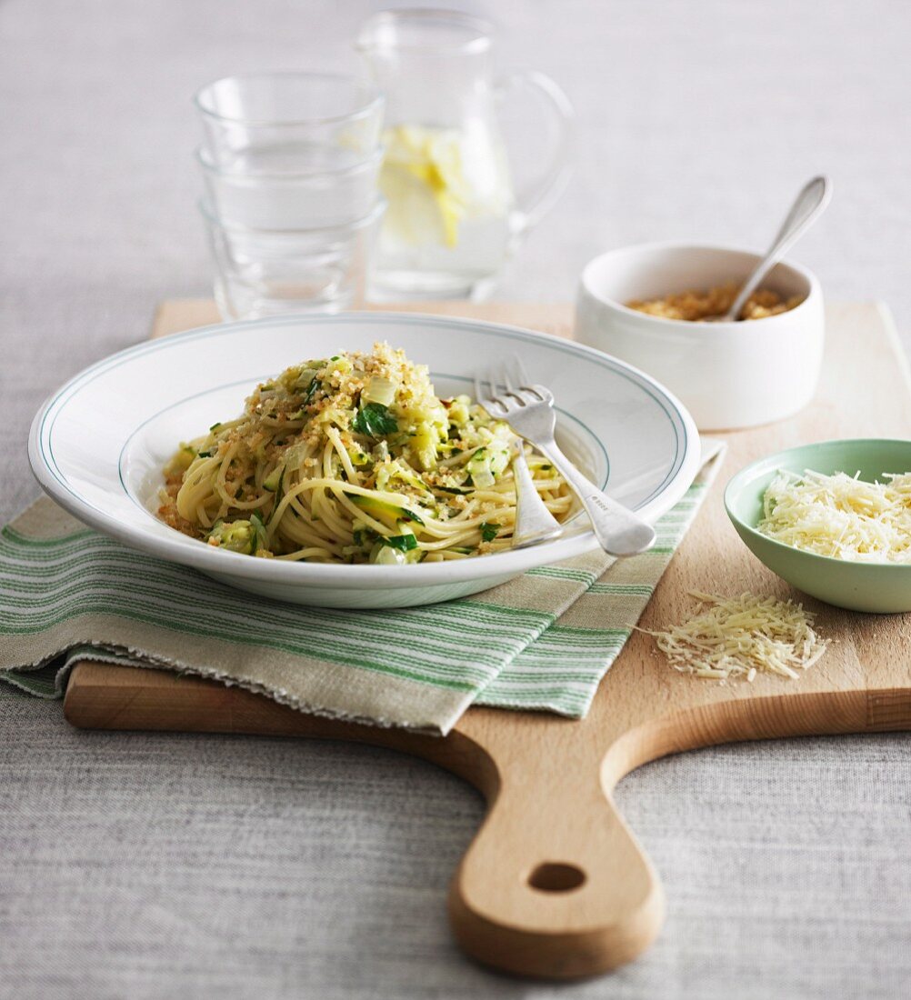 Spaghetti with courgette, crumbles and parmesan