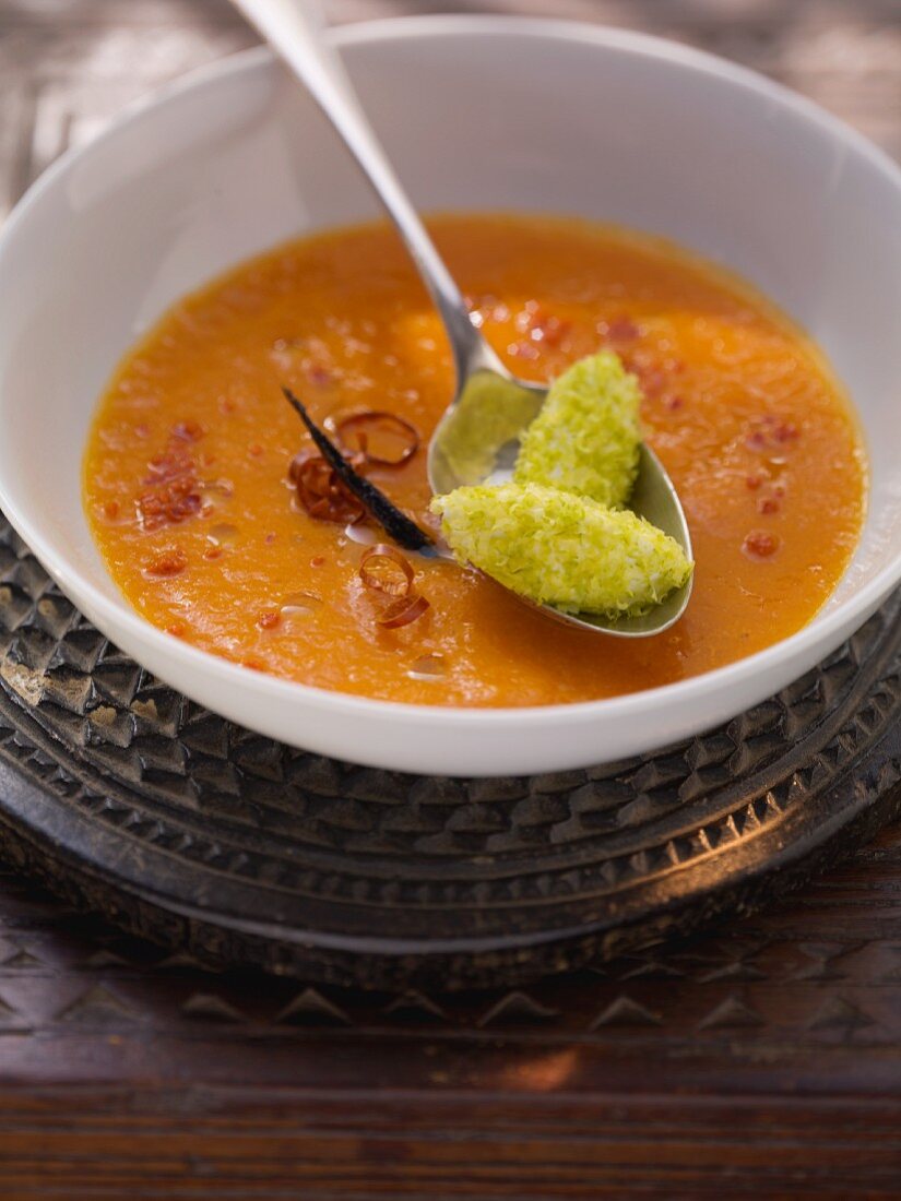Spicy tomato and carrot soup with yogurt and pistachio dumplings