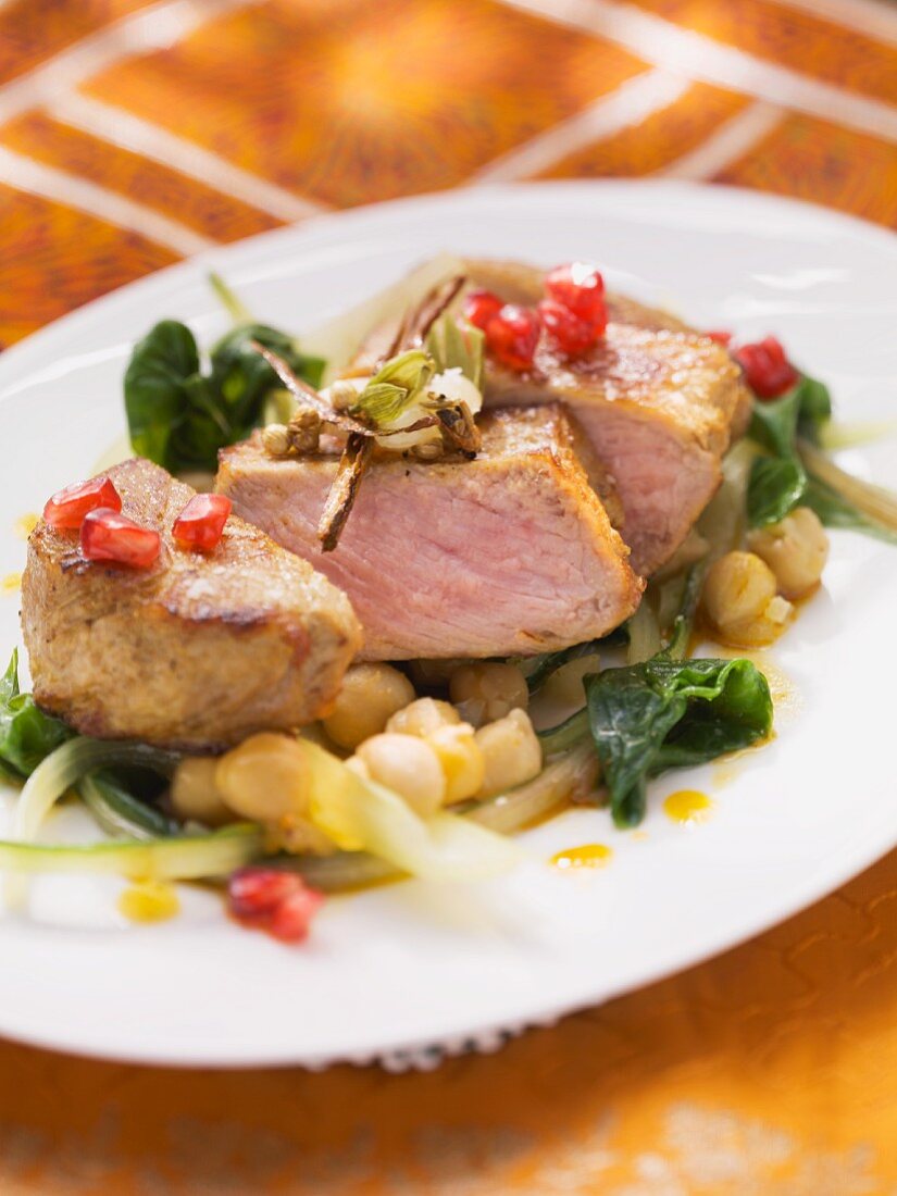 Medium rare saddle of veal on a bed of chard and chickpeas
