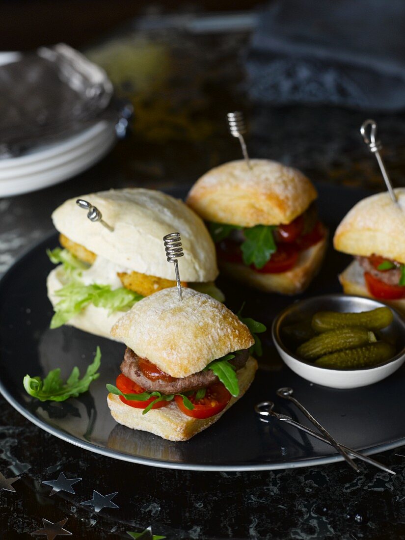 Various mini burgers and gherkins