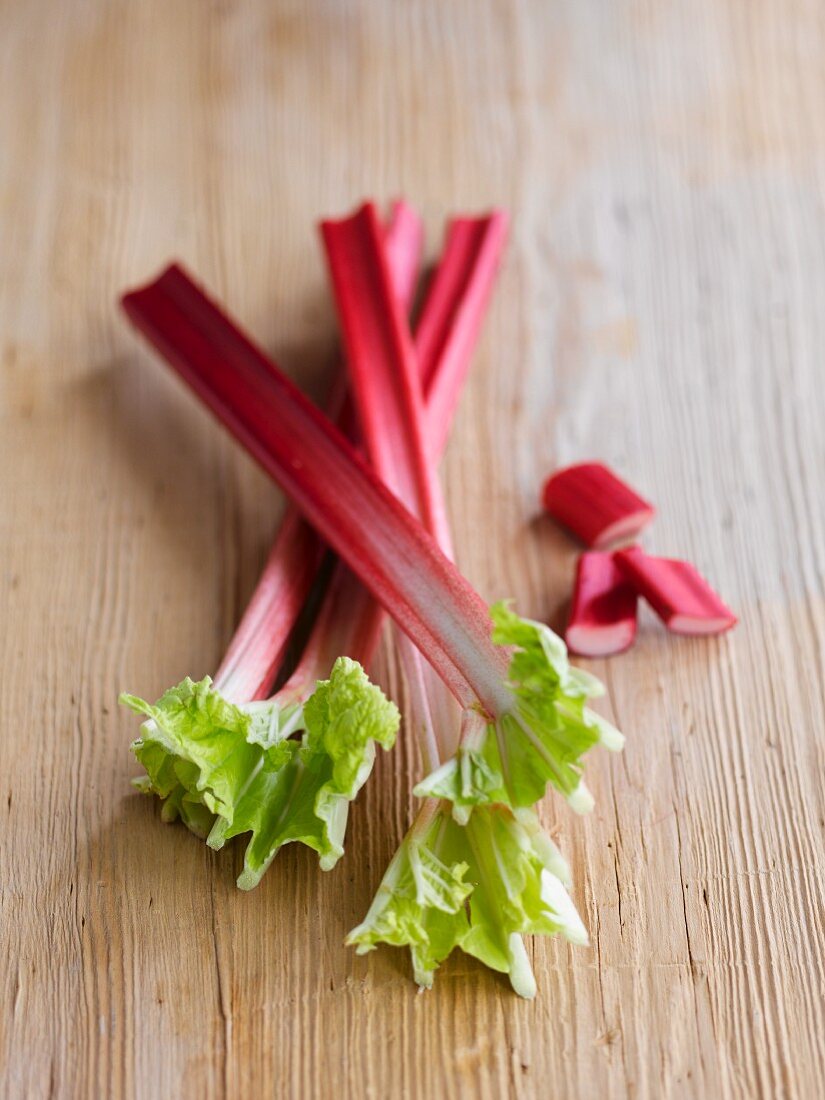 Fresh rhubarb on a wooden surface