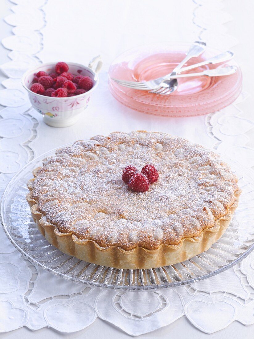 Raspberry tart with icing sugar