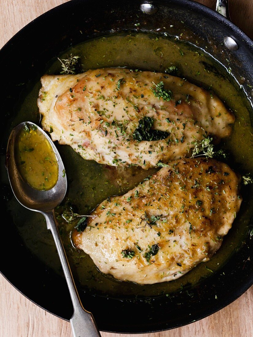 Chicken breast with herbs in a pan