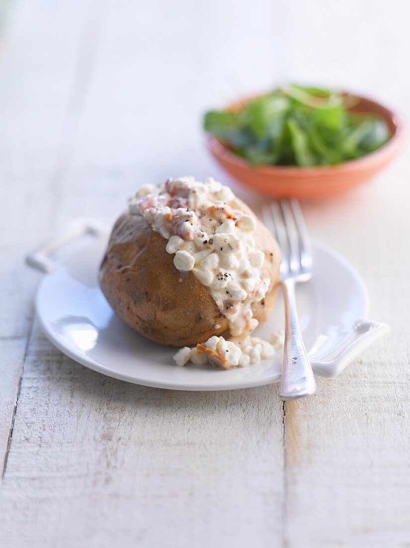 A baked potato with cottage cheese