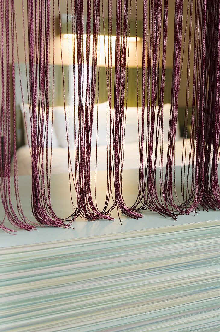 View through thread curtain in various shades of red