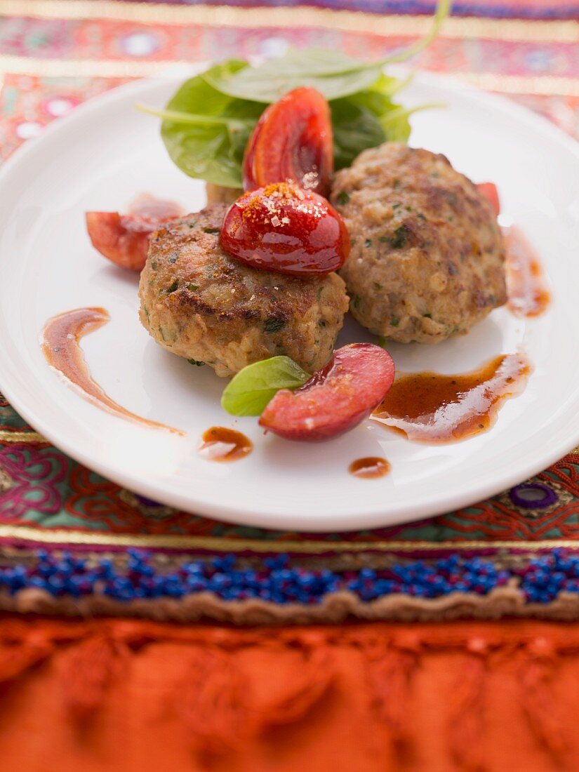 Bulgur and minced meat dumplings with cherry compote