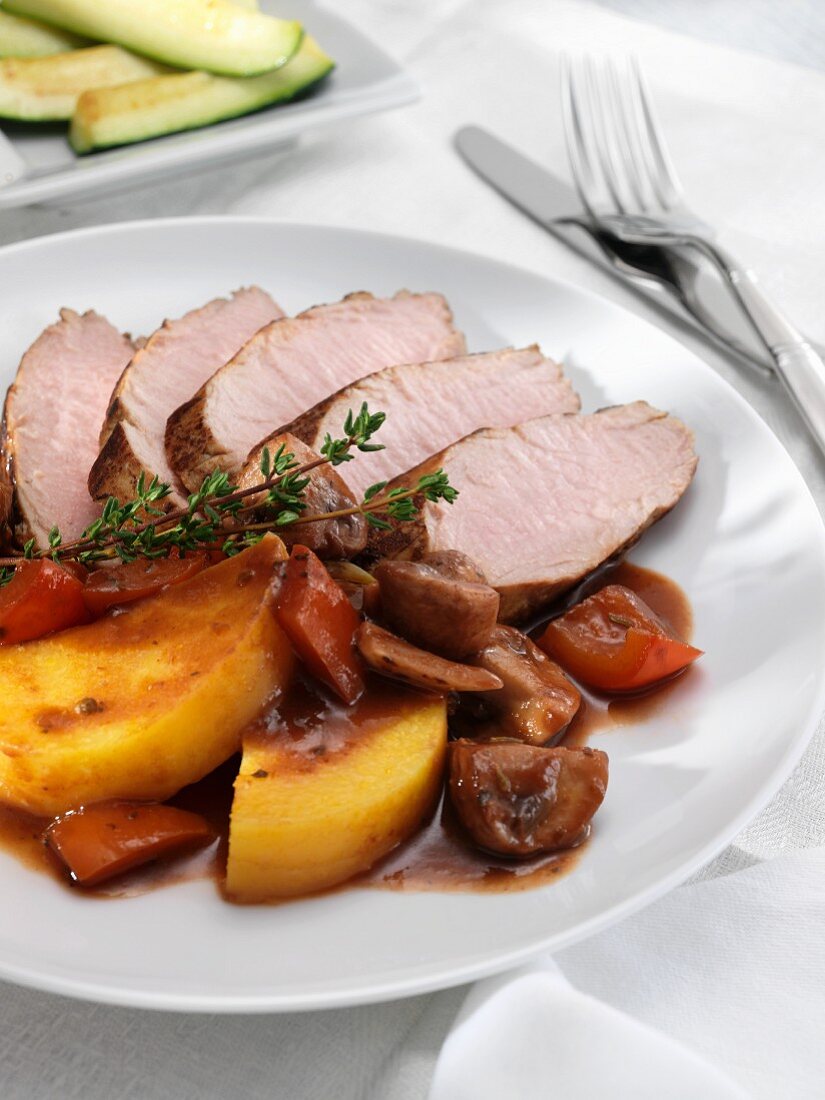 Sliced Pork Tenderloin with Roasted Vegetables and Red Wine Sauce