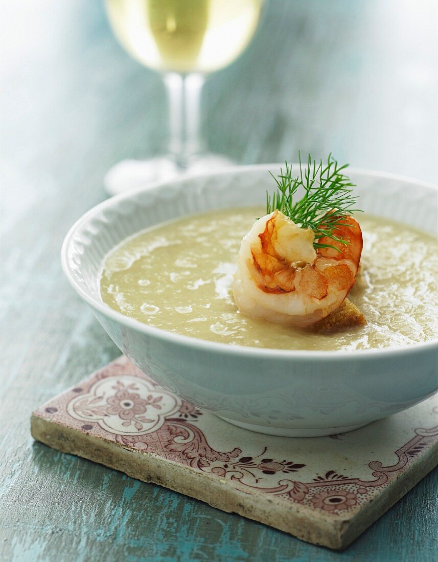 Cream of potato soup with prawns and dill