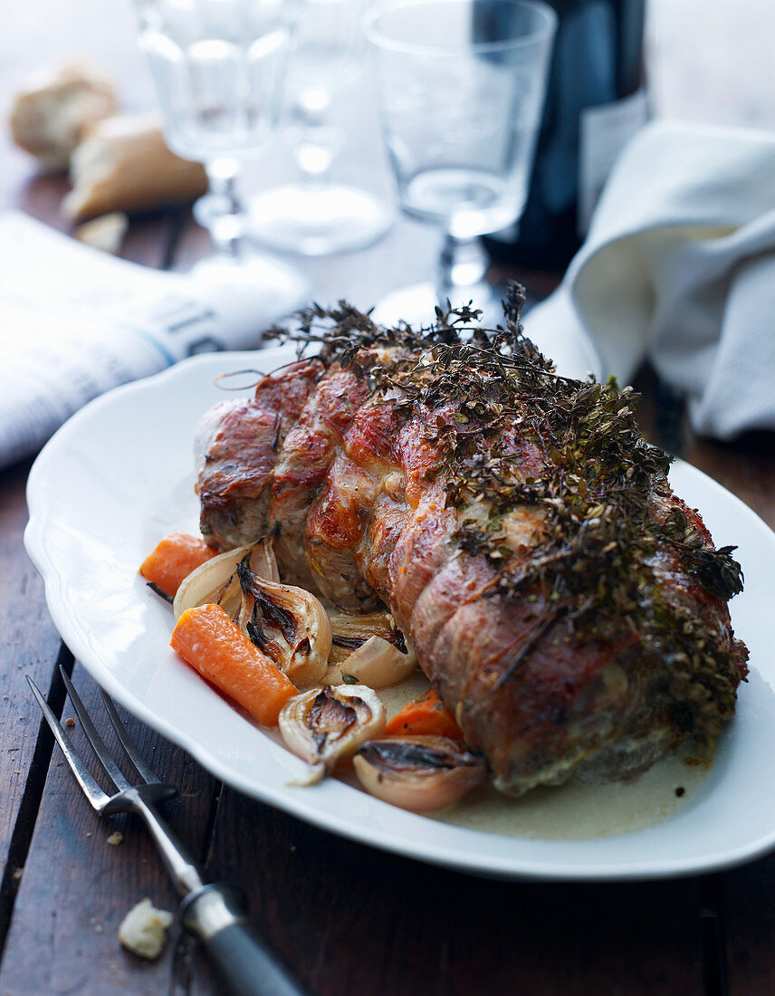 Roast pork roulade with herbs and vegetables