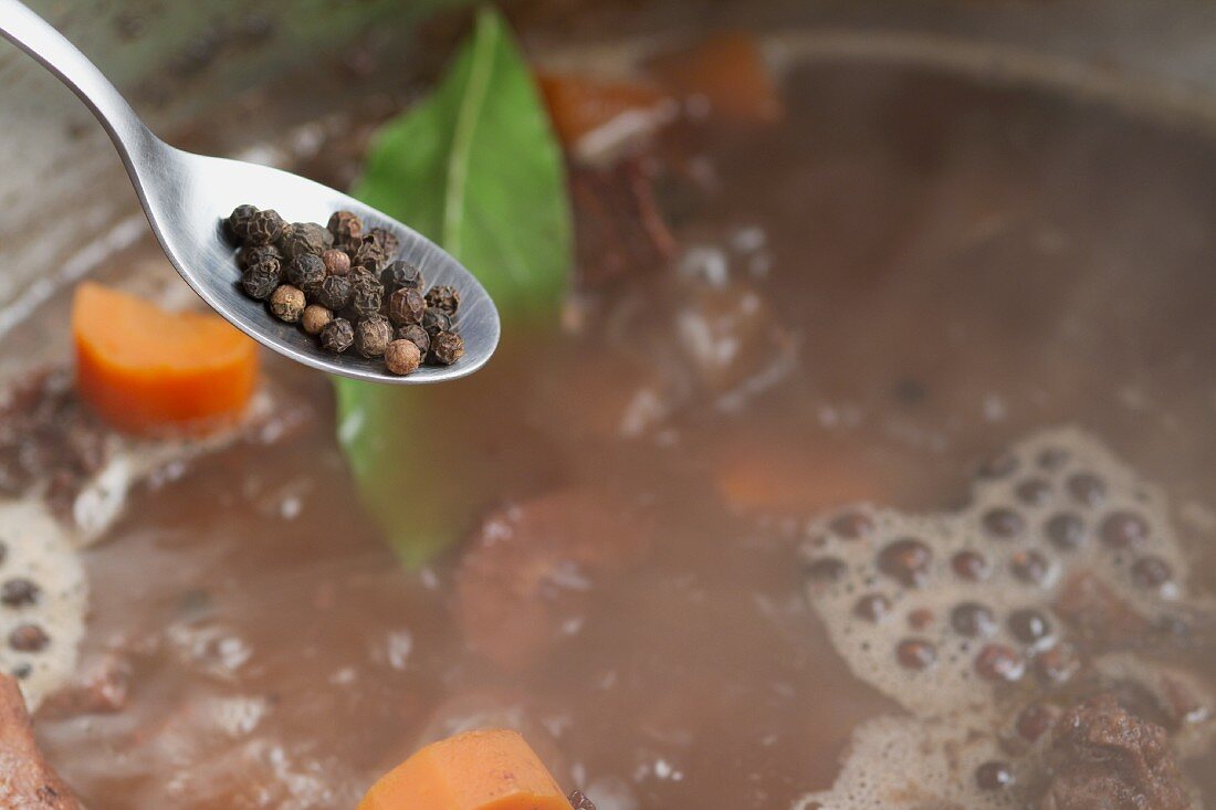 Juniper berries being added to veal stock