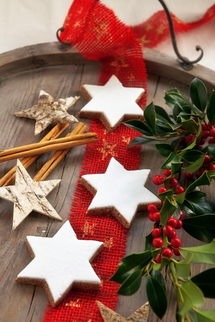 Cinnamon stars, sprigs of holly, cinnamon stick and wooden stars