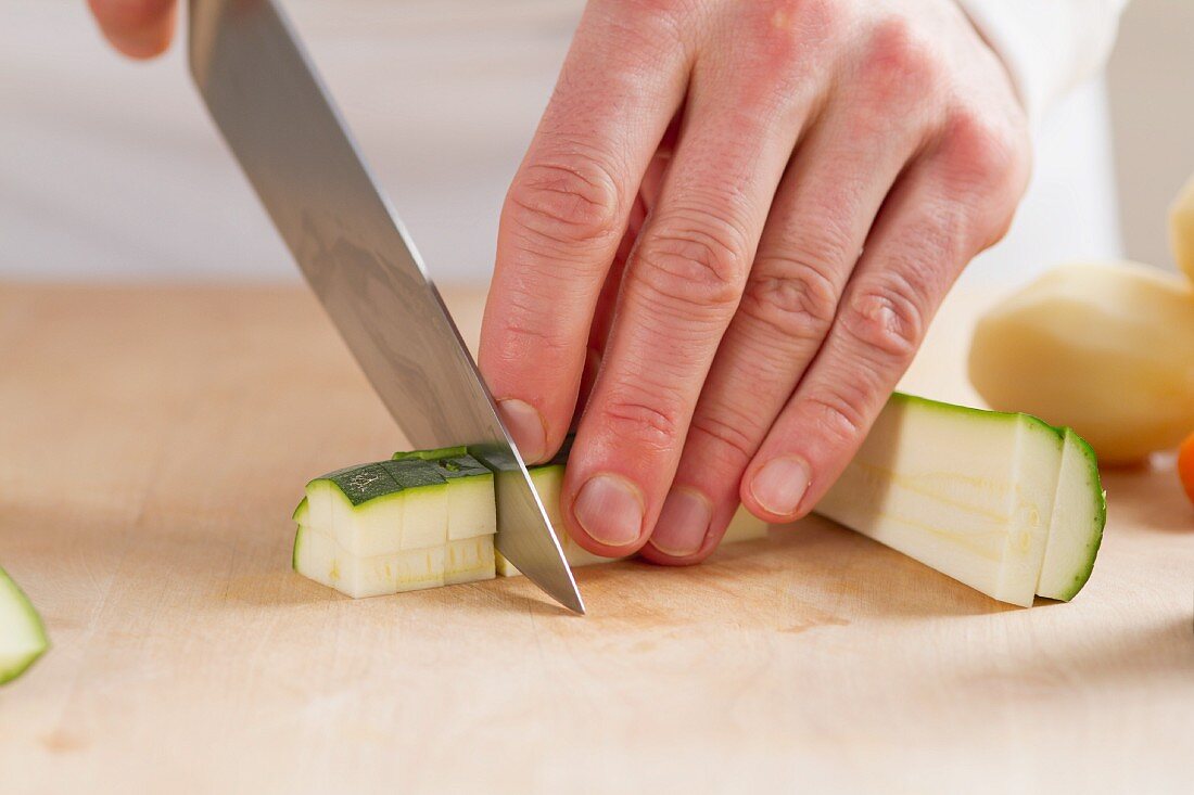 A courgette being chopped