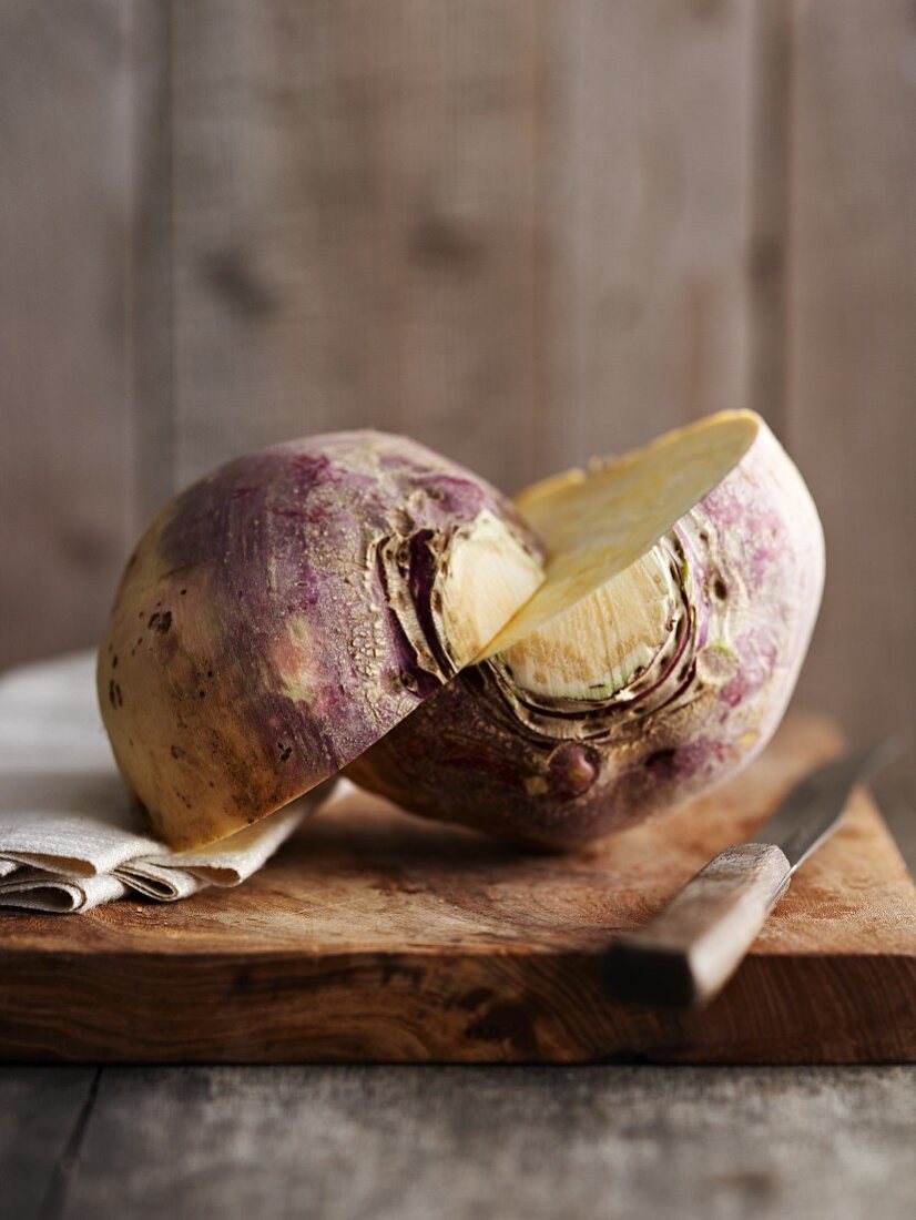 A turnip, halved, on a chopping board