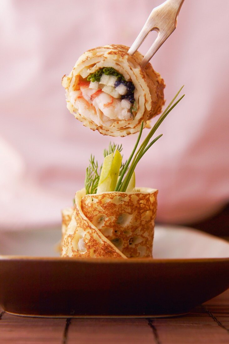 Pancake rolls with surimi and caviar