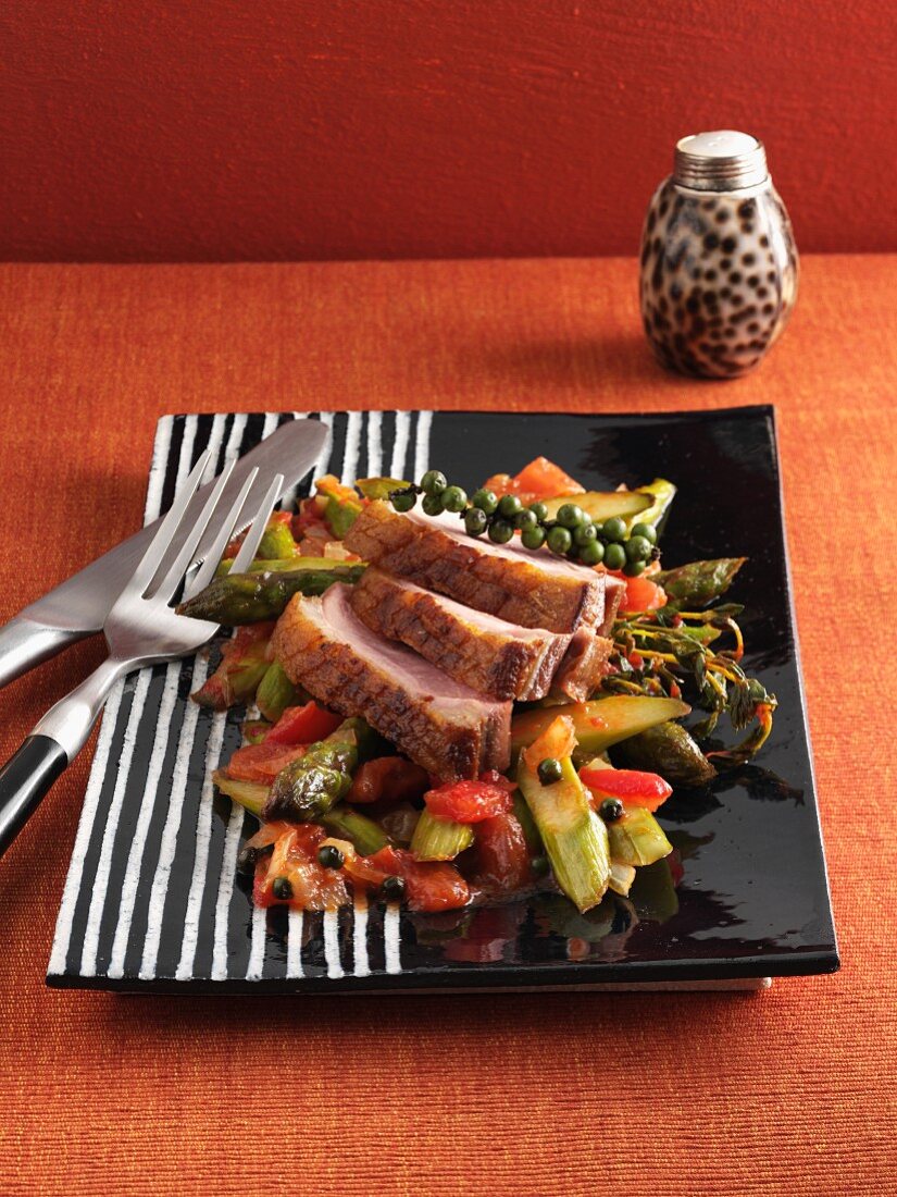 Roast duck breast on a sweet and sour asparagus medley