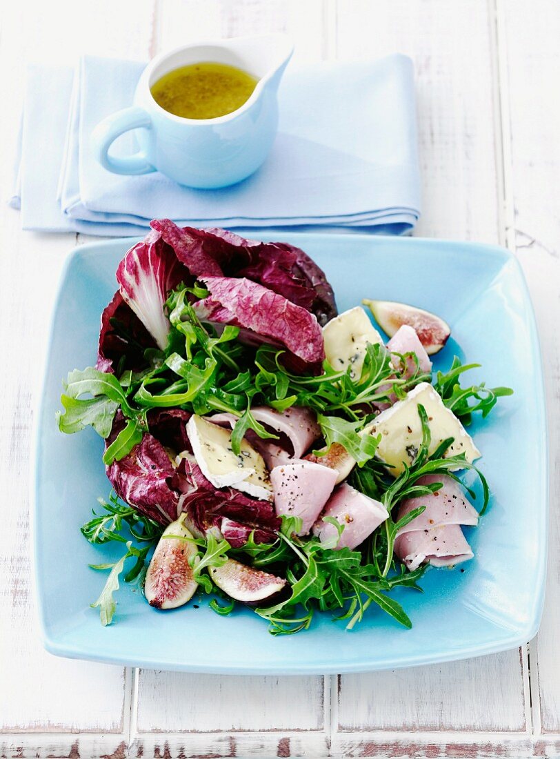 Mixed leaf salad with ham, soft cheese, figs and a honey and mustard dressing