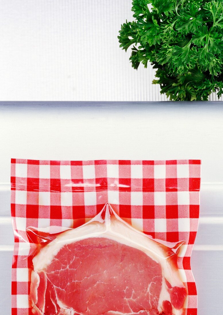 Pork chop (vacuum packed) and fresh parsley