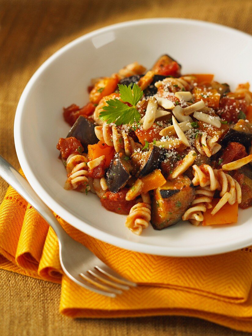 Fusilli pasta with an aubergine and pepper sauce and almonds