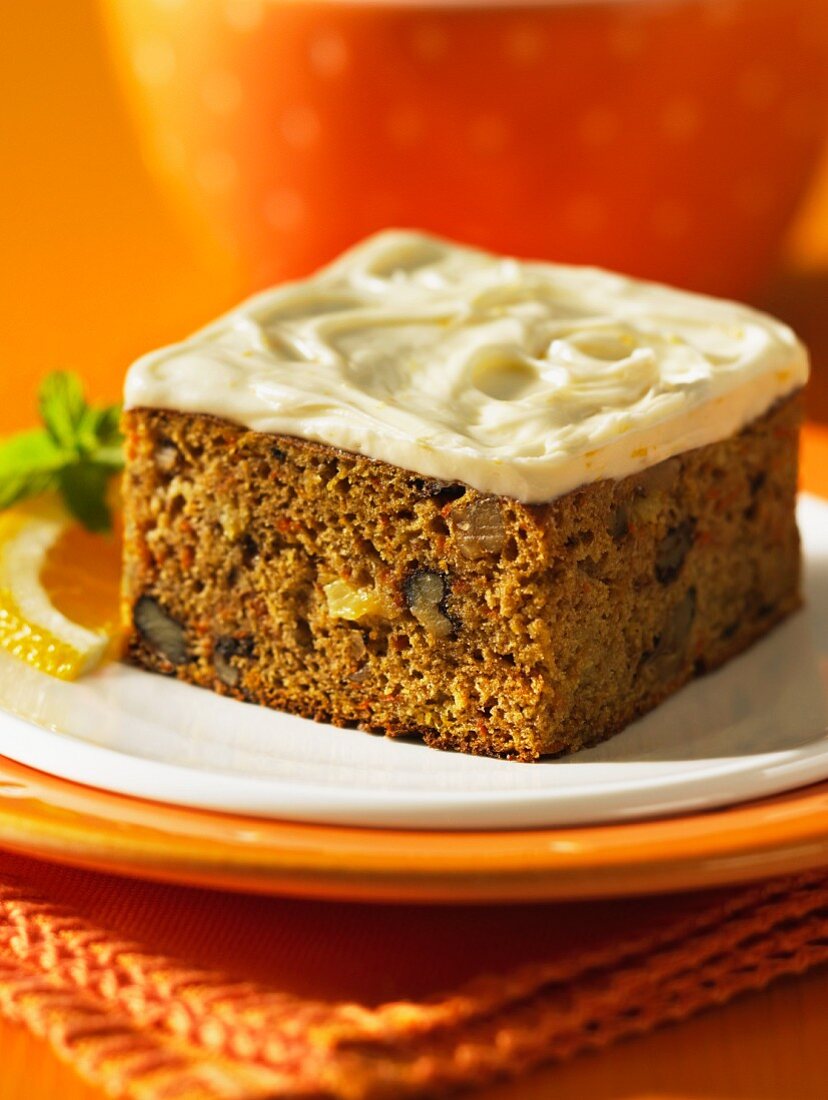 A sliced of pineapple and carrot cake with cream cheese creme