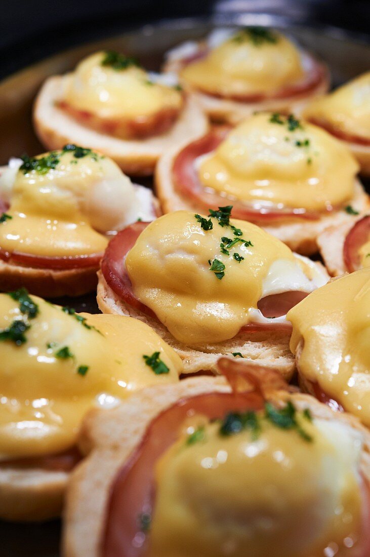 English Muffins Topped with Canadian Bacon, Eggs and Hollandaise Sauce