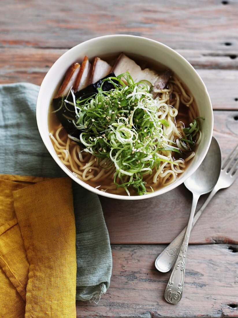 Ramen with fired pork, nori sheets and spring onions