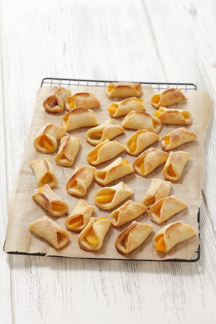 Shortbread rolls with a peach and apple filling on a wire rack
