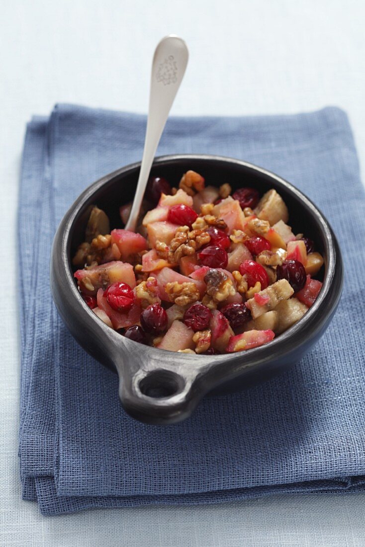 Fruit bake with apples, bananas, cranberries and walnuts