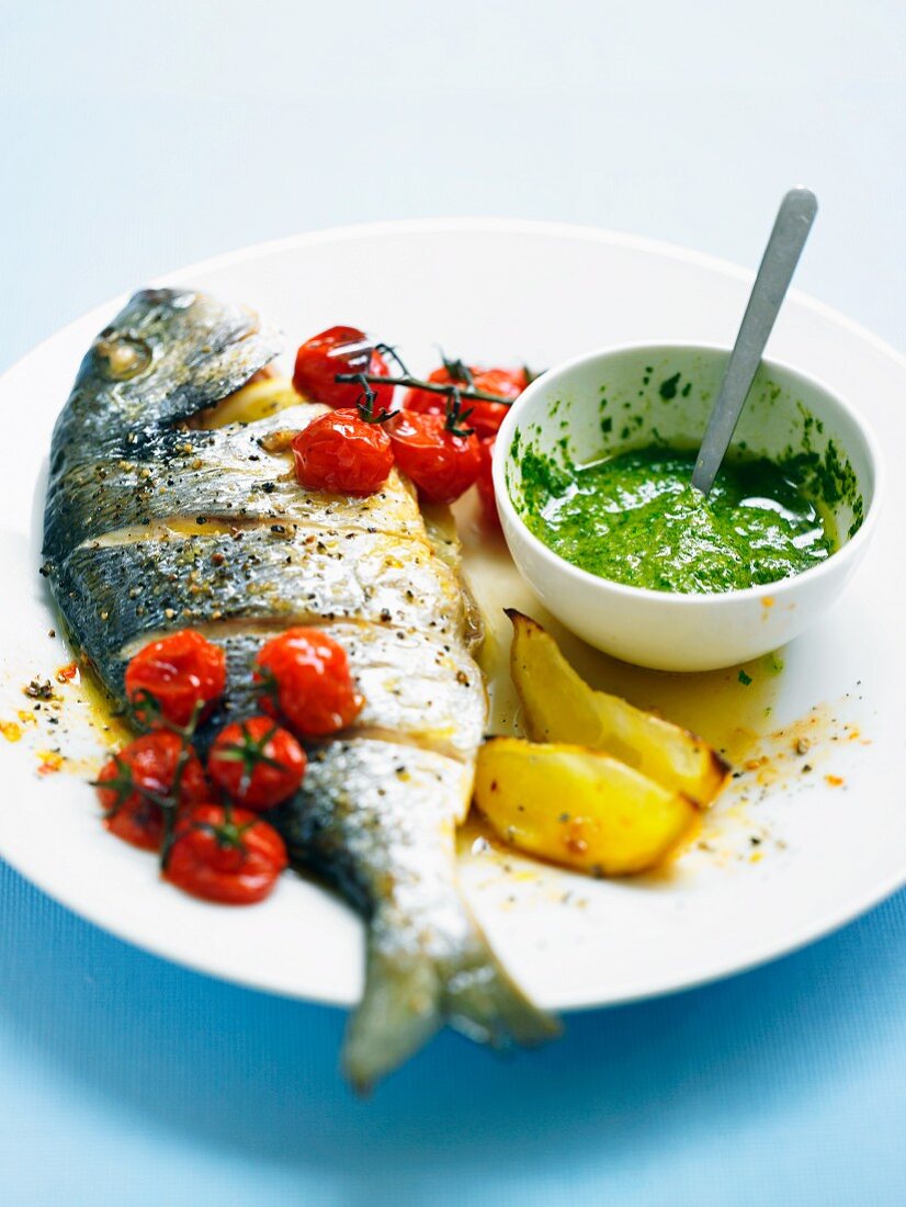 Sea bass with salsa verde, cherry tomatoes and lemons