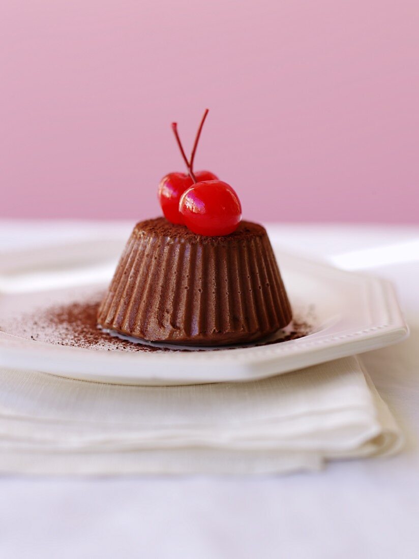 A chocolate truffle cake with cocktail cherries