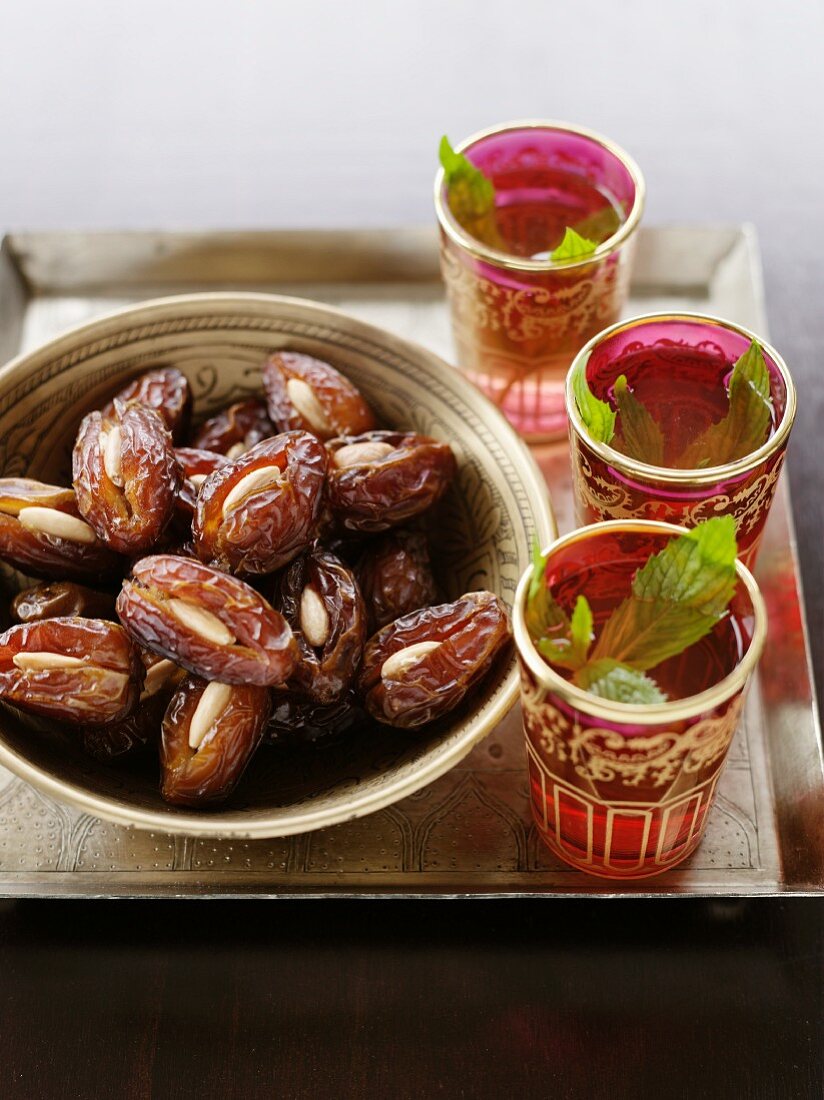 Mint tea and dates stuffed with almonds