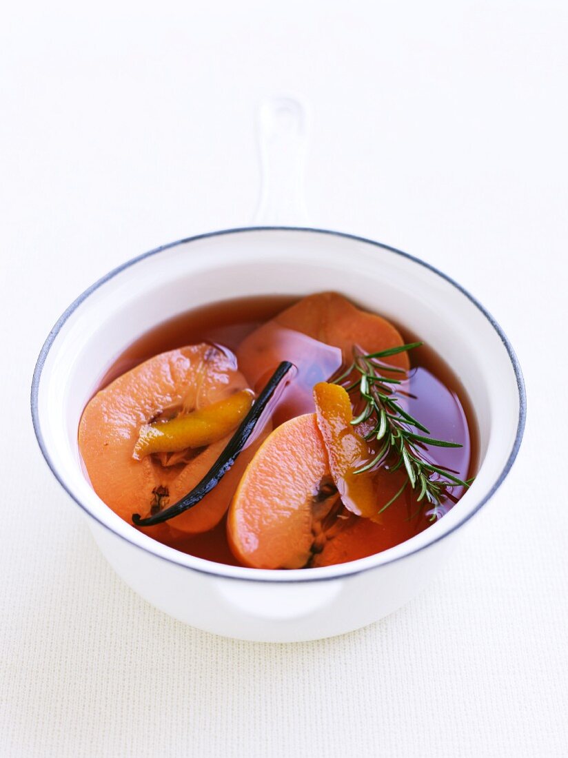 Quinces, a vanilla pod and rosemary in syrup